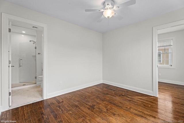 spare room featuring a ceiling fan, wood finished floors, and baseboards
