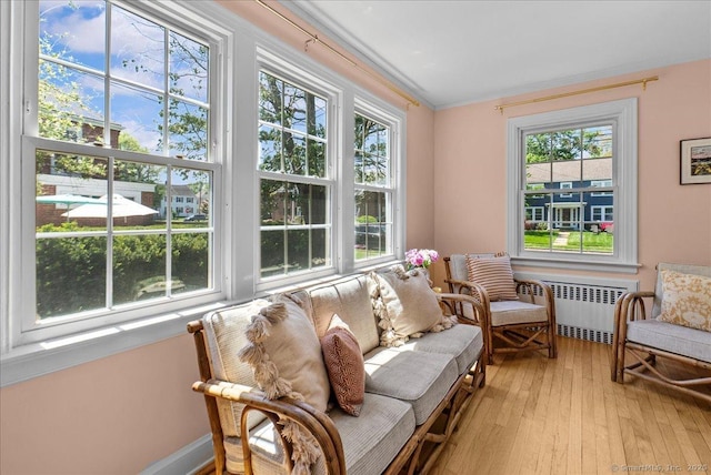 sunroom featuring radiator heating unit