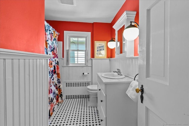 full bath featuring radiator, a wainscoted wall, toilet, vanity, and a shower with shower curtain