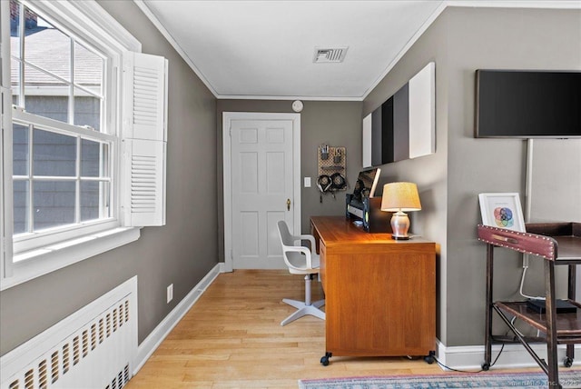 office space with radiator heating unit, ornamental molding, light wood-style flooring, and baseboards