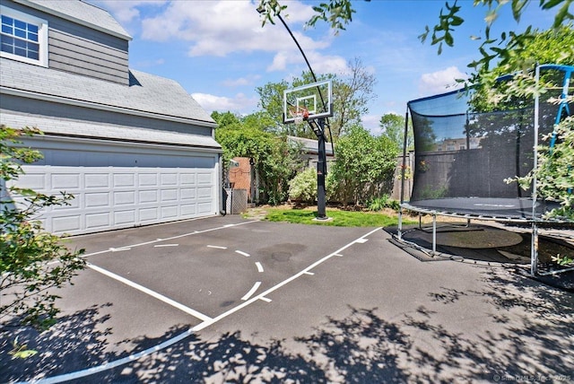 view of basketball court with a trampoline