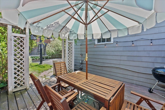 deck with a trampoline and outdoor dining area