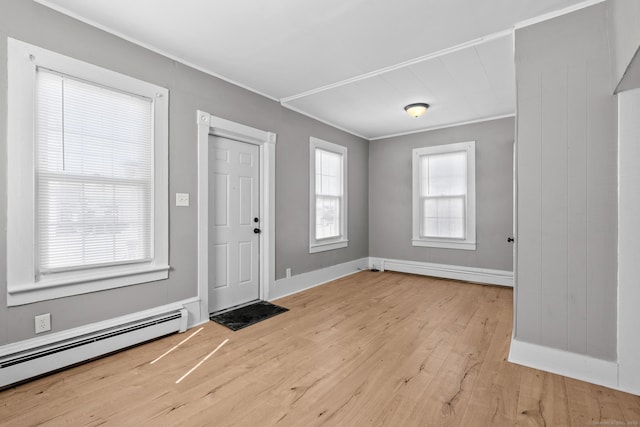 69 Trinity St, New Britain, CT 06051 - entryway with baseboard heating, wood finished floors, baseboards, a baseboard radiator, and crown molding
