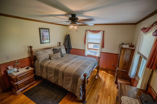 bedroom with crown molding, light wood-type flooring, a ceiling fan, and baseboards