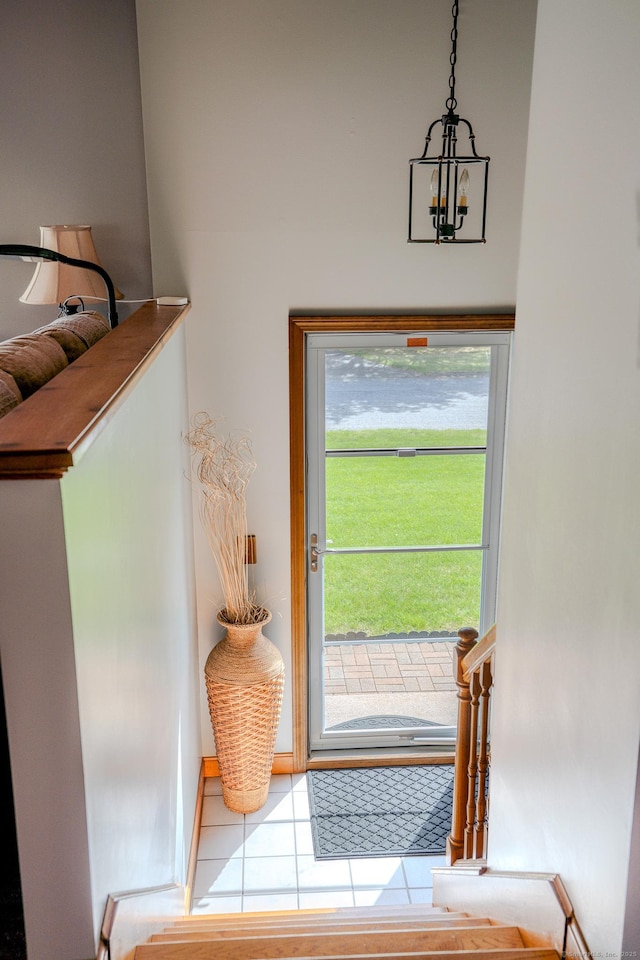 doorway to outside featuring a chandelier and tile patterned floors