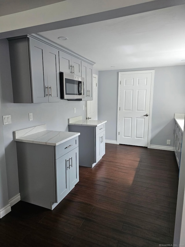 2 Apple Hill Rd, Wolcott, CT 06716 - kitchen featuring stainless steel microwave, baseboards, dark wood-type flooring, and gray cabinets
