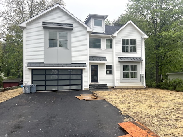 264 Harvester Rd, Fairfield, CT 06825 - view of front facade with a standing seam roof, driveway, and metal roof
