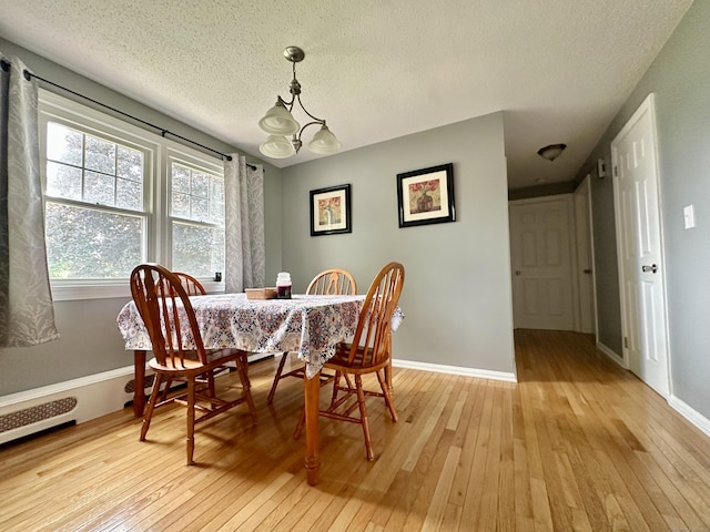 260 W Center St, Southington, CT 06489 - dining area with light wood-style floors, a textured ceiling, baseboards, and a chandelier