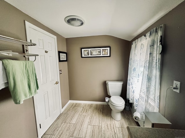 260 W Center St, Southington, CT 06489 - bathroom with toilet, vaulted ceiling, wood tiled floors, and baseboards