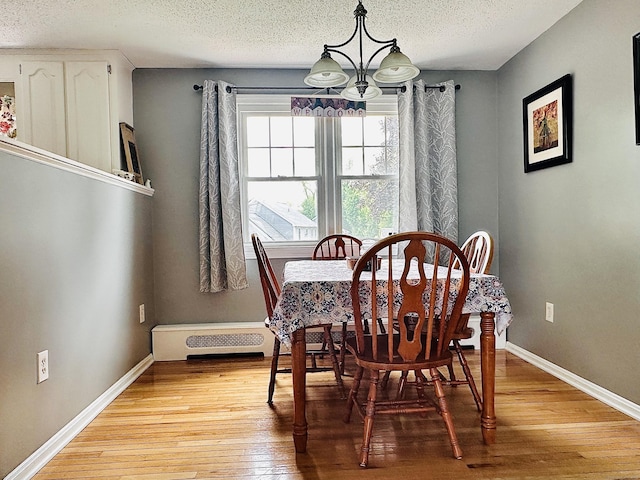 260 W Center St, Southington, CT 06489 - dining space with light wood-style flooring, a chandelier, a textured ceiling, and baseboards