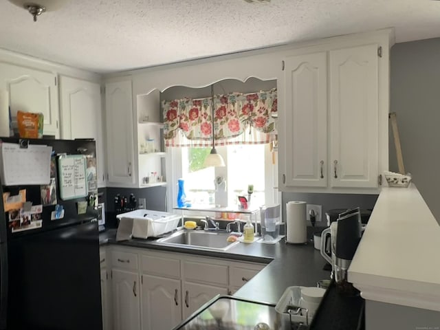 260 W Center St, Southington, CT 06489 - kitchen with freestanding refrigerator, a sink, white cabinetry, a textured ceiling, and open shelves
