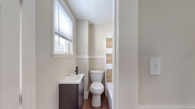 bathroom with toilet and wood finished floors
