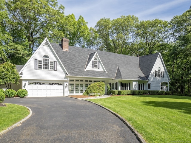 25 Powder Horn Hill Rd, Wilton, CT 06897 - view of front of house featuring asphalt driveway, a front lawn, a chimney, a garage, and a shingled roof