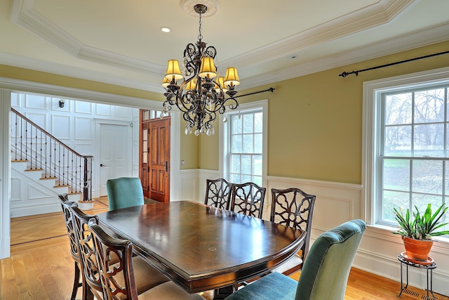 84 Mustang Dr, Monroe, CT 06468 - dining area with a chandelier, plenty of natural light, light wood finished floors, ornamental molding, and a wainscoted wall