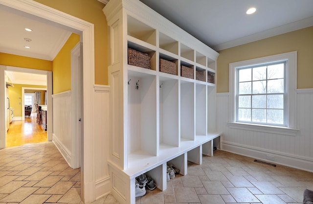84 Mustang Dr, Monroe, CT 06468 - mudroom featuring ornamental molding, a wainscoted wall, stone tile flooring, and a decorative wall