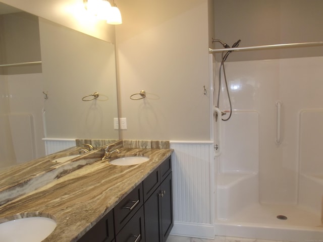 94 Stonehouse Rd Unit 16, Coventry, CT 06238 - full bath featuring wainscoting, double vanity, and a shower