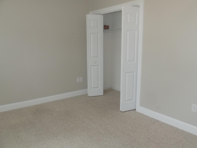 94 Stonehouse Rd Unit 16, Coventry, CT 06238 - unfurnished bedroom with light colored carpet, a closet, and baseboards