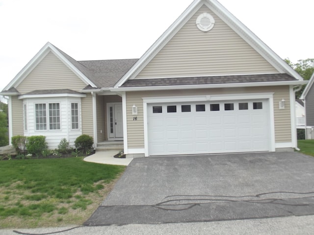 94 Stonehouse Rd Unit 16, Coventry, CT 06238 - view of front of property with asphalt driveway, an attached garage, a shingled roof, and a front lawn