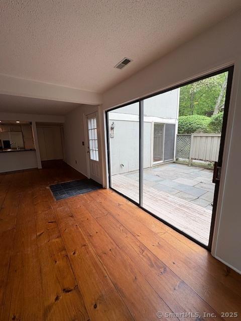 34 Clubhouse Dr Unit 23C, Woodbury, CT 06798 - doorway to outside with a textured ceiling and light wood-style floors