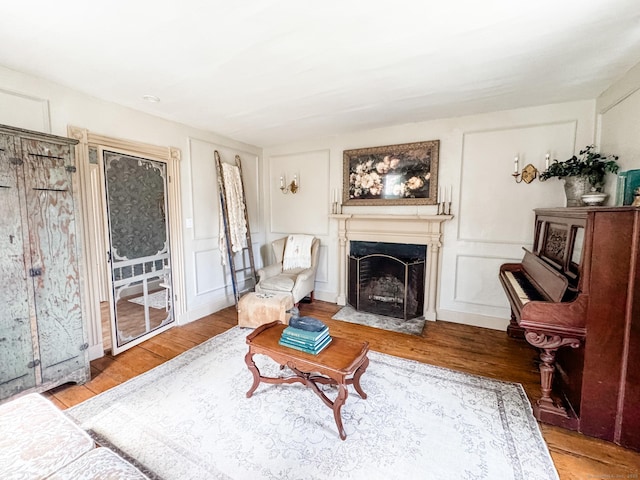 49 Bennett Pond Rd, Canterbury, CT 06331 - living room featuring a fireplace with flush hearth, wood finished floors, and a decorative wall