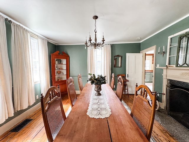 49 Bennett Pond Rd, Canterbury, CT 06331 - dining space featuring a chandelier, healthy amount of natural light, light wood-type flooring, and crown molding