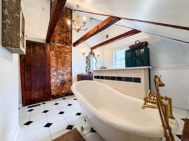 49 Bennett Pond Rd, Canterbury, CT 06331 - bathroom with brick wall, a freestanding tub, a chandelier, and tile patterned flooring