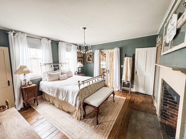 49 Bennett Pond Rd, Canterbury, CT 06331 - bedroom featuring hardwood / wood-style floors, a fireplace, and a chandelier