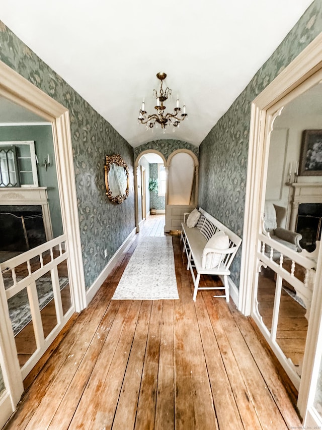 49 Bennett Pond Rd, Canterbury, CT 06331 - hallway featuring wallpapered walls, arched walkways, hardwood / wood-style floors, a chandelier, and vaulted ceiling