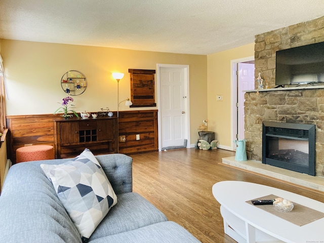 67 S Beechwood Rd, East Lyme, CT 06357 - living area featuring wood finished floors, a fireplace, and a textured ceiling