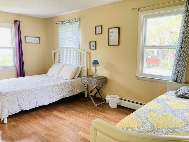 67 S Beechwood Rd, East Lyme, CT 06357 - bedroom with baseboard heating and light wood-style flooring