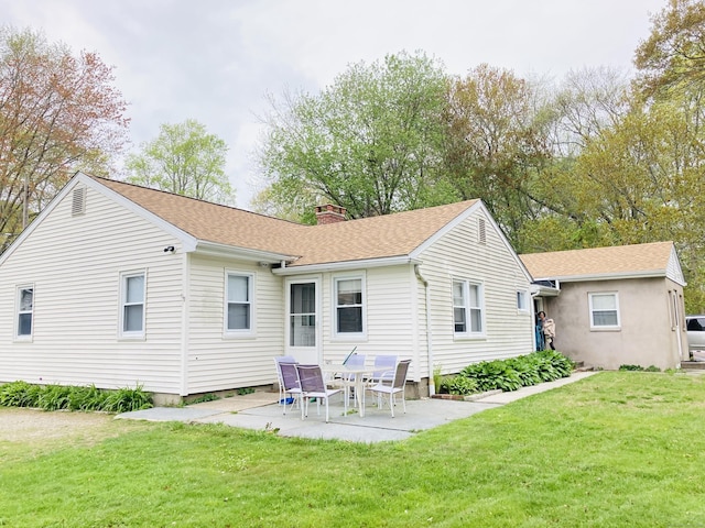 67 S Beechwood Rd, East Lyme, CT 06357 - rear view of house featuring a chimney, a patio area, a lawn, and a shingled roof