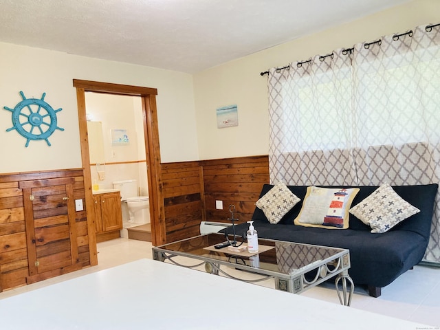 67 S Beechwood Rd, East Lyme, CT 06357 - living room with a baseboard heating unit and a wainscoted wall