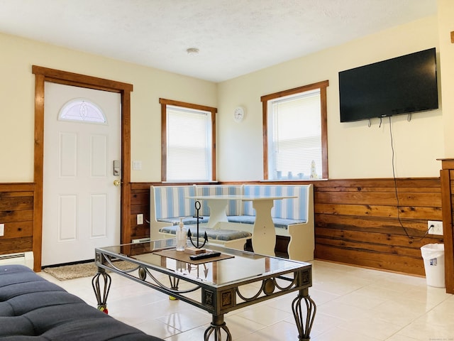 67 S Beechwood Rd, East Lyme, CT 06357 - living area featuring a wainscoted wall, wooden walls, light tile patterned flooring, and a textured ceiling