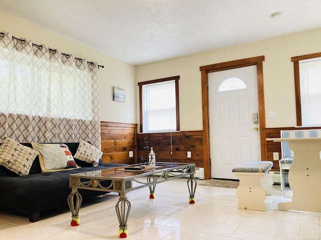 67 S Beechwood Rd, East Lyme, CT 06357 - living room with wainscoting, wood walls, and light tile patterned floors