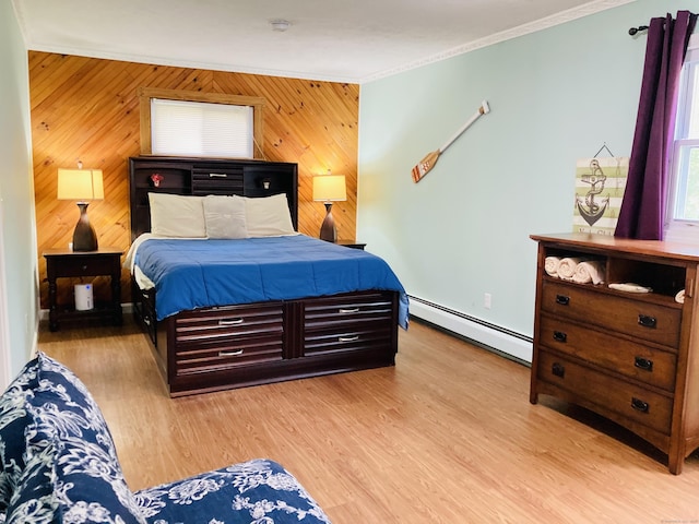 67 S Beechwood Rd, East Lyme, CT 06357 - bedroom with baseboard heating, ornamental molding, wood walls, light wood-style flooring, and baseboards