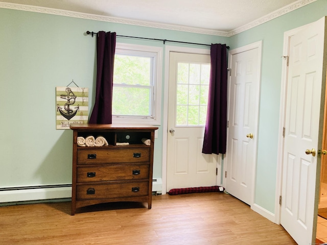 67 S Beechwood Rd, East Lyme, CT 06357 - bedroom featuring crown molding, light wood-style flooring, baseboard heating, and a baseboard radiator