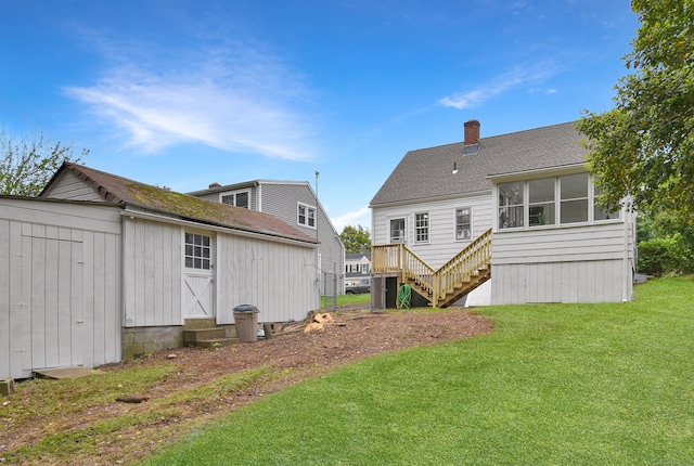 145 Westminster St, Hamden, CT 06518 - rear view of property featuring a lawn, a chimney, entry steps, stairs, and a shingled roof