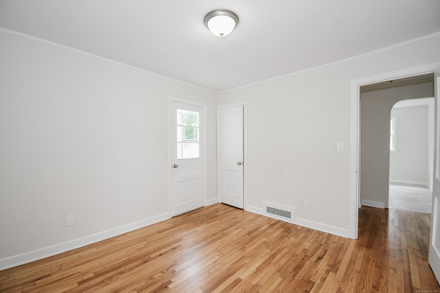 145 Westminster St, Hamden, CT 06518 - empty room featuring arched walkways, ornamental molding, wood finished floors, and baseboards