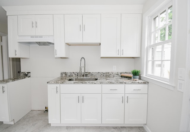 145 Westminster St, Hamden, CT 06518 - kitchen featuring under cabinet range hood, a sink, light stone countertops, and white cabinetry