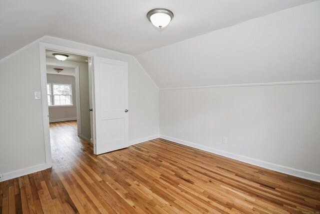 145 Westminster St, Hamden, CT 06518 - additional living space with light wood-style flooring, lofted ceiling, and baseboards