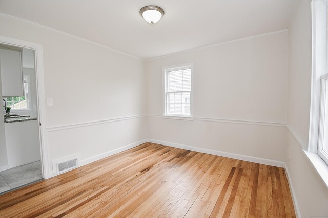 145 Westminster St, Hamden, CT 06518 - empty room featuring hardwood / wood-style flooring, ornamental molding, and baseboards