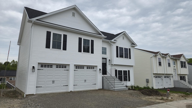 40 Yorktown Rdg, Waterbury, CT 06704 - view of front facade with an attached garage, asphalt driveway, and stairs