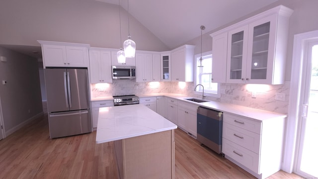 40 Yorktown Rdg, Waterbury, CT 06704 - kitchen with stainless steel appliances, a sink, a center island, white cabinets, and high vaulted ceiling
