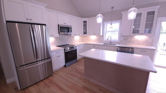 40 Yorktown Rdg, Waterbury, CT 06704 - kitchen with appliances with stainless steel finishes, a sink, lofted ceiling, white cabinetry, and tasteful backsplash