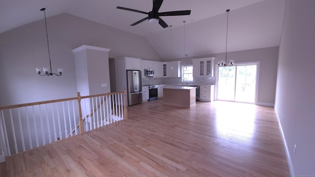 40 Yorktown Rdg, Waterbury, CT 06704 - unfurnished living room featuring a chandelier, a sink, light wood-type flooring, and high vaulted ceiling