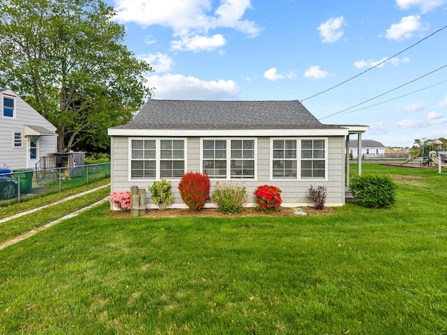 74 Chalker Beach Rd, Old Saybrook, CT 06475 - view of front of home featuring roof with shingles and a playground