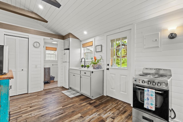 74 Chalker Beach Rd, Old Saybrook, CT 06475 - kitchen featuring stainless steel electric range oven, freestanding refrigerator, lofted ceiling, dark wood-type flooring, and light countertops