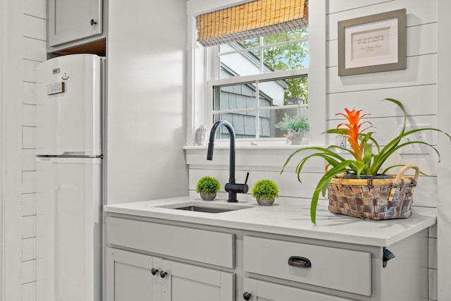 74 Chalker Beach Rd, Old Saybrook, CT 06475 - kitchen with freestanding refrigerator, a sink, and light countertops