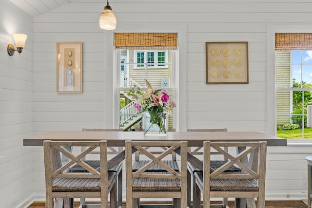74 Chalker Beach Rd, Old Saybrook, CT 06475 - dining room featuring wooden walls, wood finished floors, and vaulted ceiling