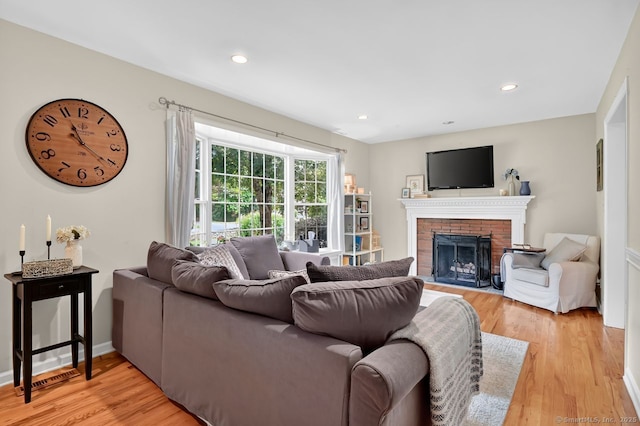 49 Bear Hills Rd, Newtown, CT 06470 - living area featuring light wood finished floors, a brick fireplace, and recessed lighting
